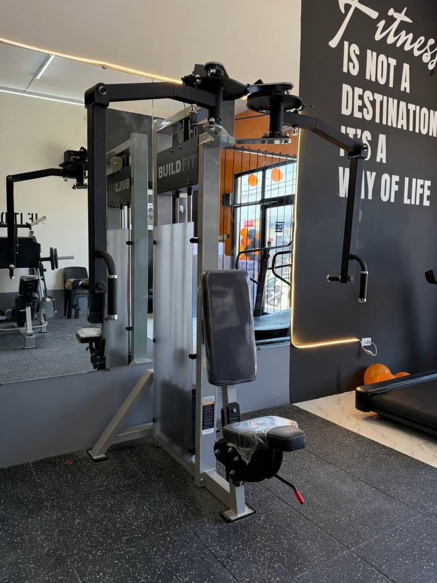 FitForge gym — cable machine station and motivational mural