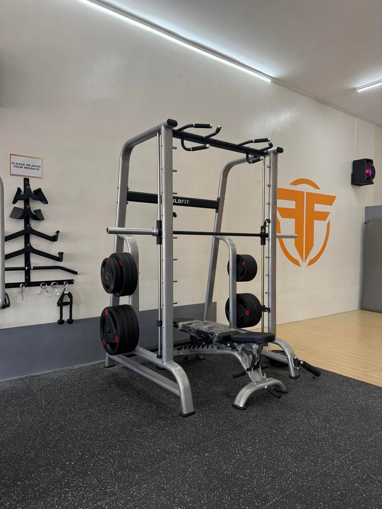 Smith machine station — FitForge logo wall
