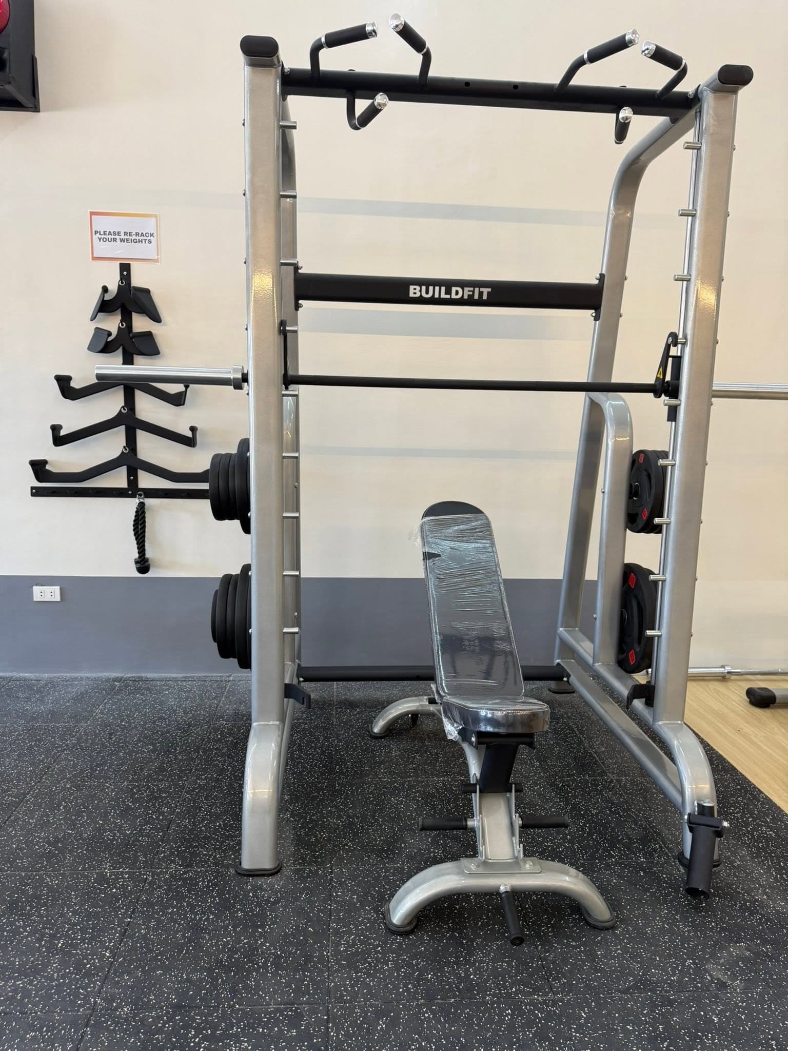 Smith machine with adjustable bench